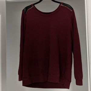 Red sweater with leather accents and zippers